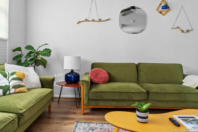 a living room with furniture and a mirror