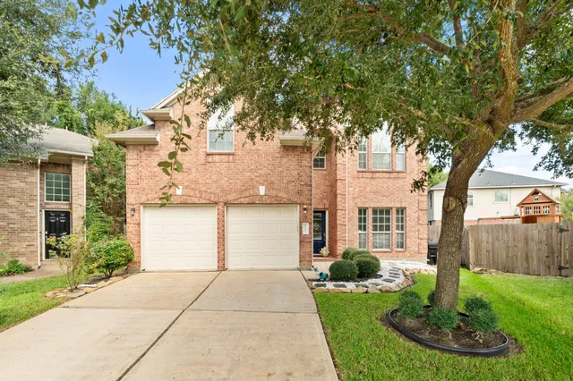a front view of a house with a yard garage and fountain