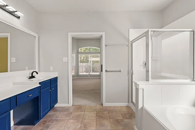 a spacious bathroom with a shower and a sink