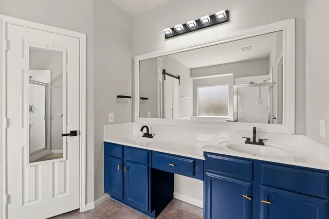 a bathroom with a double vanity sink and mirror