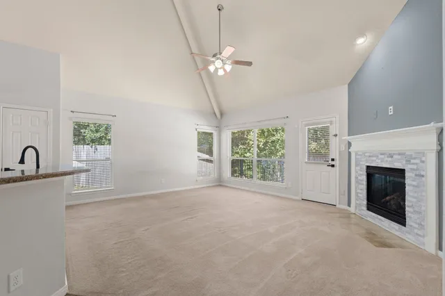 a view of a livingroom with a ceiling fan and window