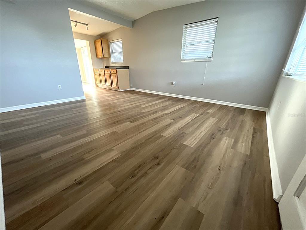9596 Groveland Street Seminole, FL 33772 - Photo 17 of 26 a view of an empty room with wooden floor and a window
