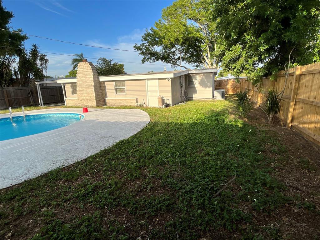 9596 Groveland Street Seminole, FL 33772 - Photo 2 of 26 a front view of a house with a yard and garage