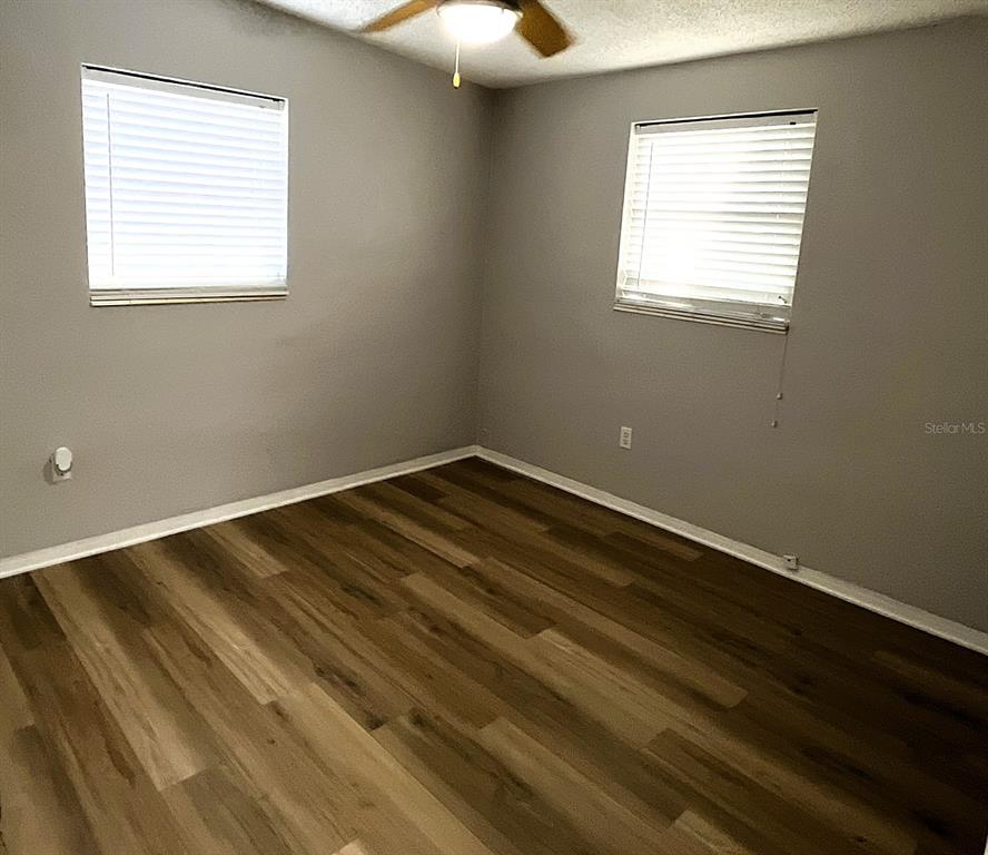 9596 Groveland Street Seminole, FL 33772 - Photo 21 of 26 a view of a room with wooden floor and windows
