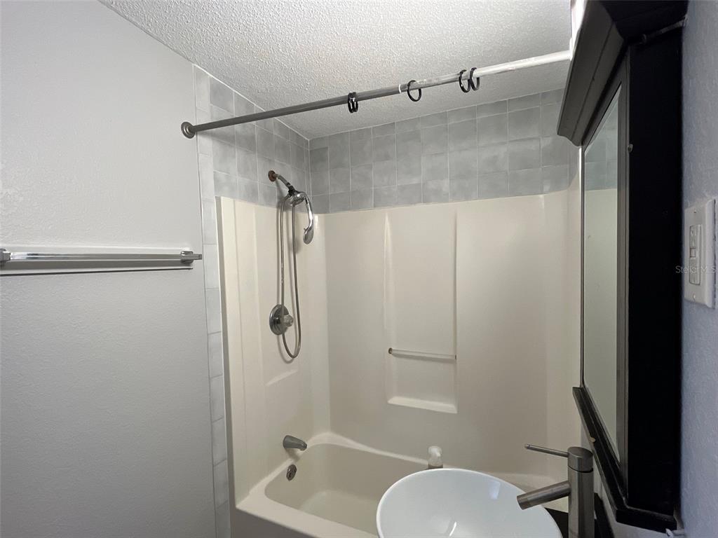 9596 Groveland Street Seminole, FL 33772 - Photo 26 of 26 a bathroom with a granite countertop shower sink vanity and toilet