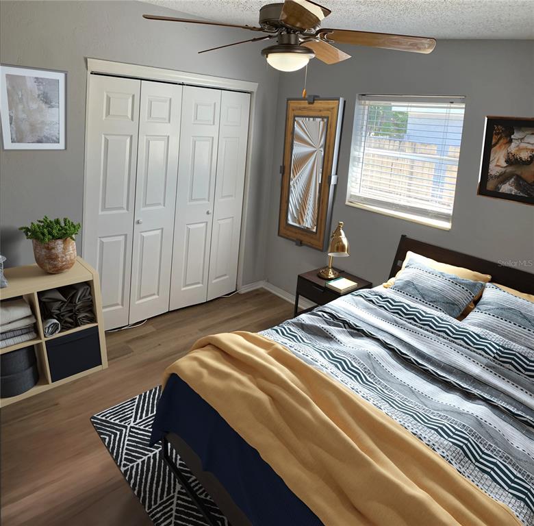 9596 Groveland Street Seminole, FL 33772 - Photo 10 of 26 a bedroom with a bed and a chandelier