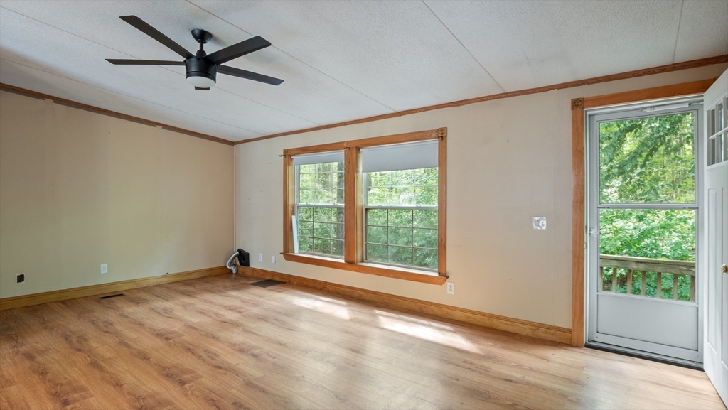 84 Forest Road Salisbury, MA 01952 - Photo 11 of 28 a view of a livingroom with a ceiling fan and a large window
