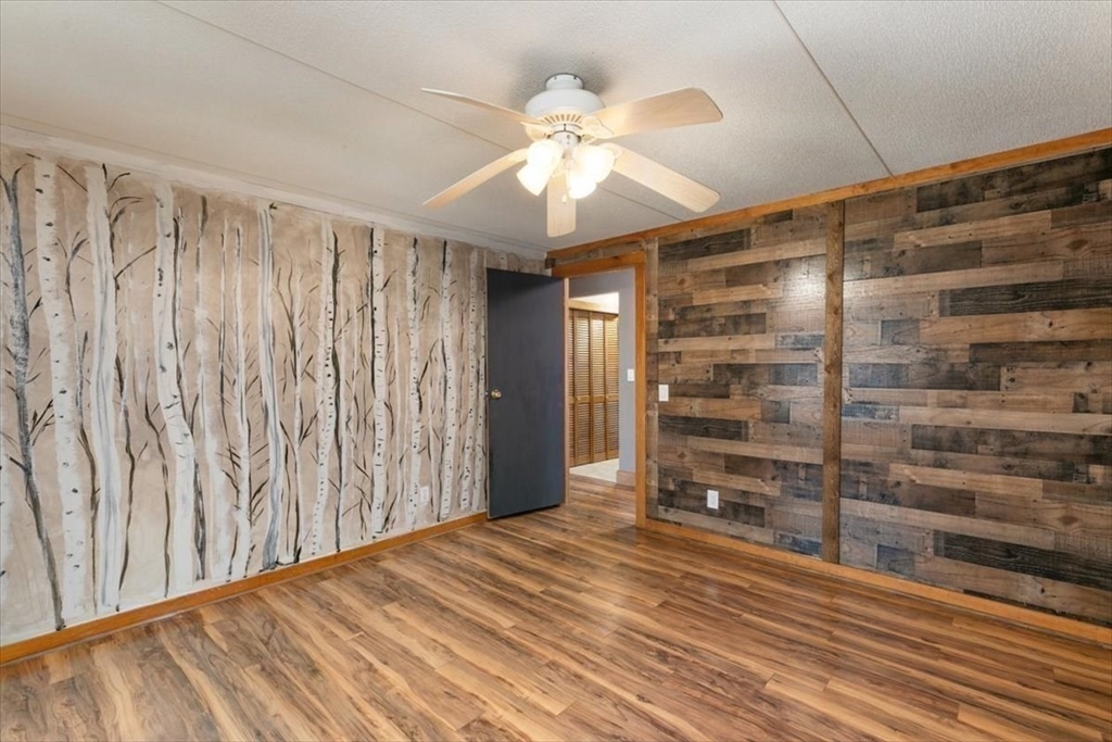 84 Forest Road Salisbury, MA 01952 - Photo 13 of 28 a view of wooden floor and chandelier fan in a room