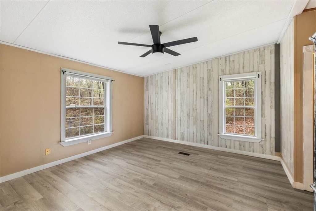 84 Forest Road Salisbury, MA 01952 - Photo 15 of 28 a view of an empty room with a window and wooden floor