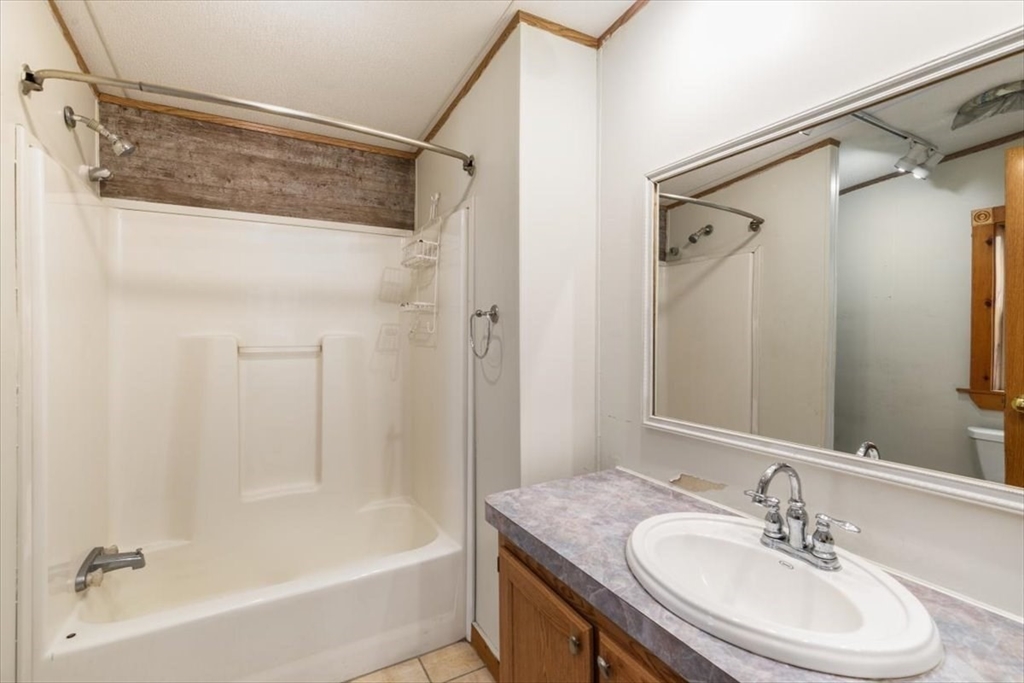 84 Forest Road Salisbury, MA 01952 - Photo 16 of 28 a bathroom with a granite countertop sink mirror and a bathtub