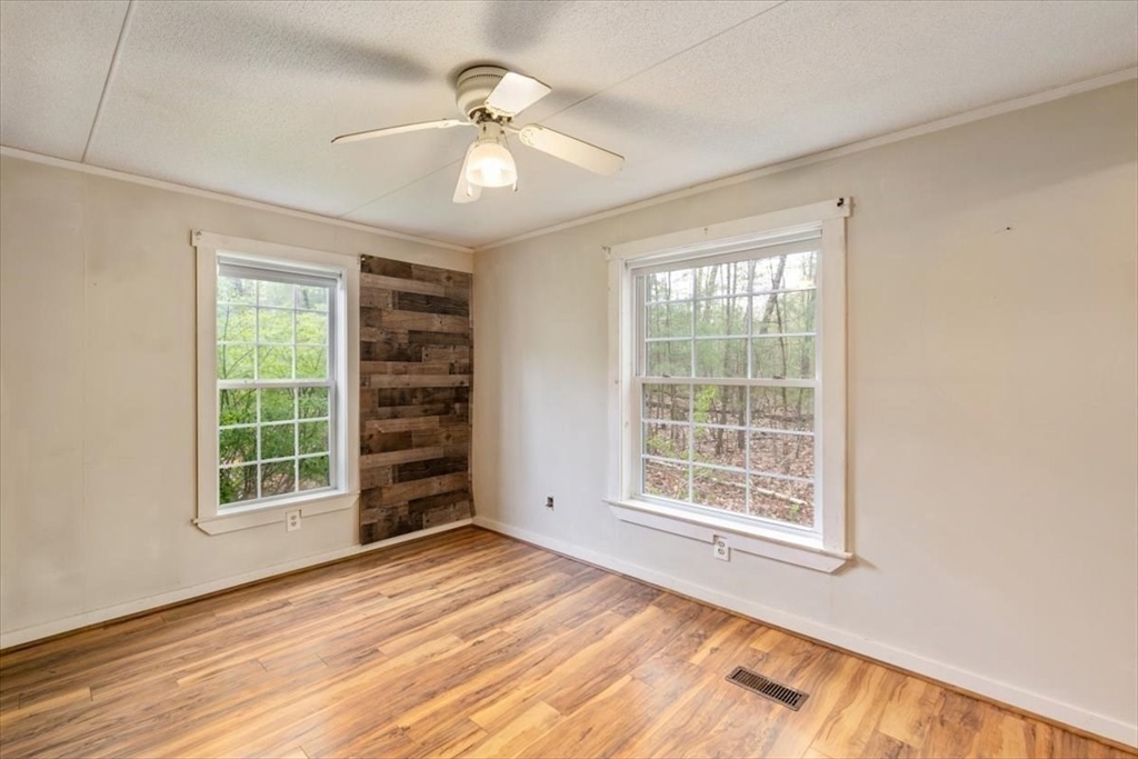 84 Forest Road Salisbury, MA 01952 - Photo 17 of 28 an empty room with windows closet and chandelier fan