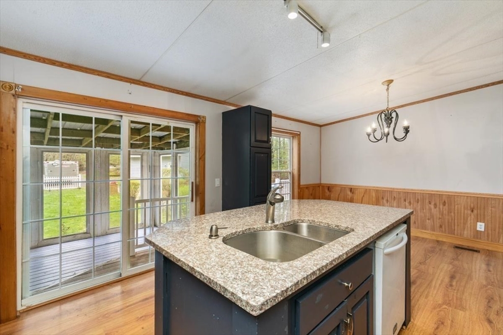 84 Forest Road Salisbury, MA 01952 - Photo 5 of 28 a kitchen with a sink a counter space and living room view
