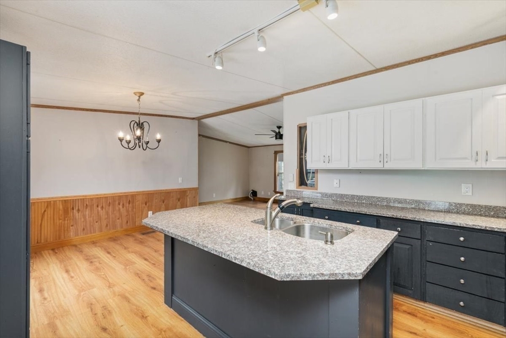 84 Forest Road Salisbury, MA 01952 - Photo 7 of 28 a kitchen with granite countertop a sink a window and a stove