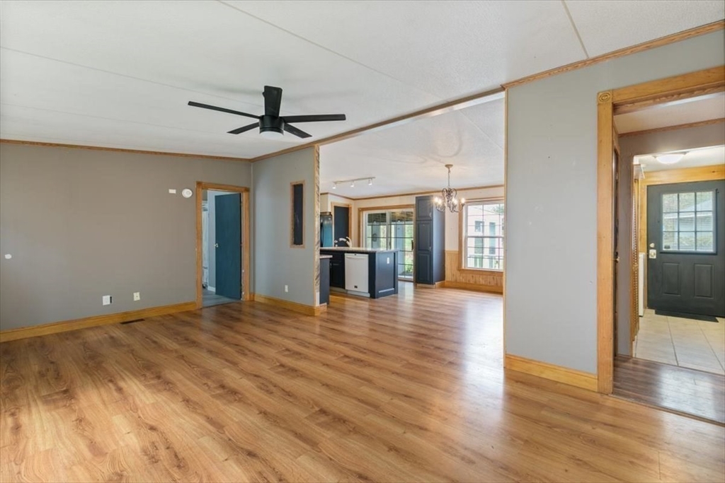 84 Forest Road Salisbury, MA 01952 - Photo 9 of 28 a view of a livingroom with wooden floor and a ceiling fan
