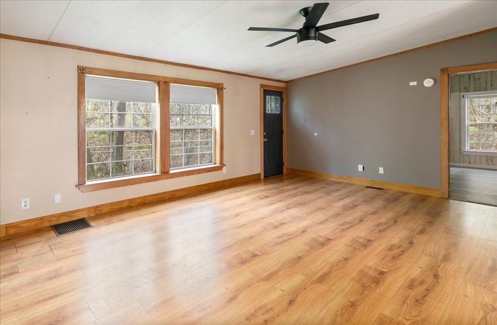 84 Forest Road Salisbury, MA 01952 - Photo 10 of 28 a view of an empty room with a window and wooden floor