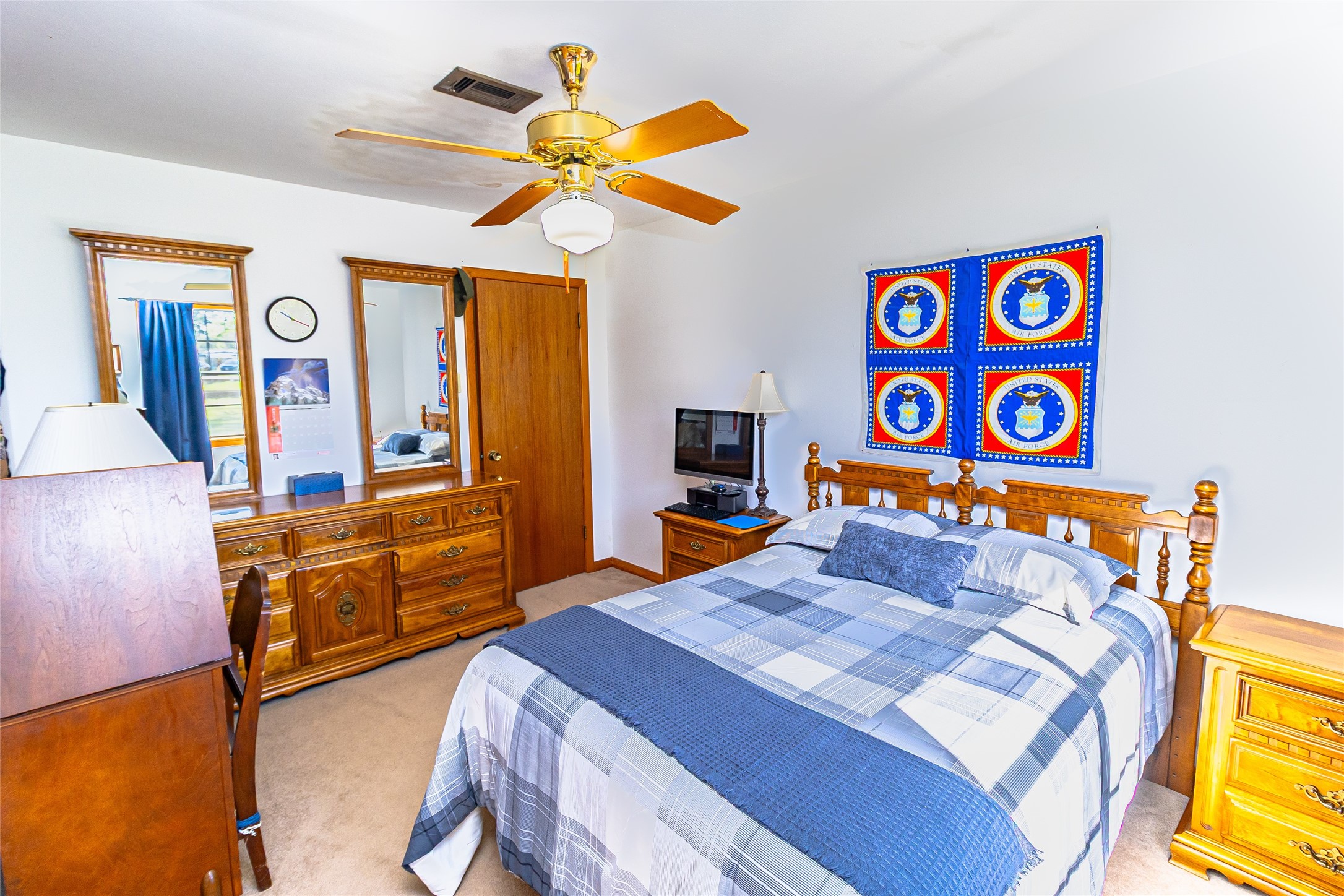 1202 Pecan Street Channelview, TX 77530 - Photo 17 of 35 a bedroom with a bed and a chandelier