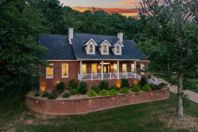 a view of a house with a yard and garden