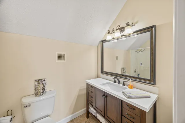 a view of bathroom with a toilet sink and next to a window