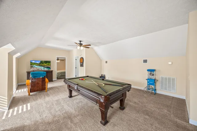 a view of a patio with table and chairs under an umbrella