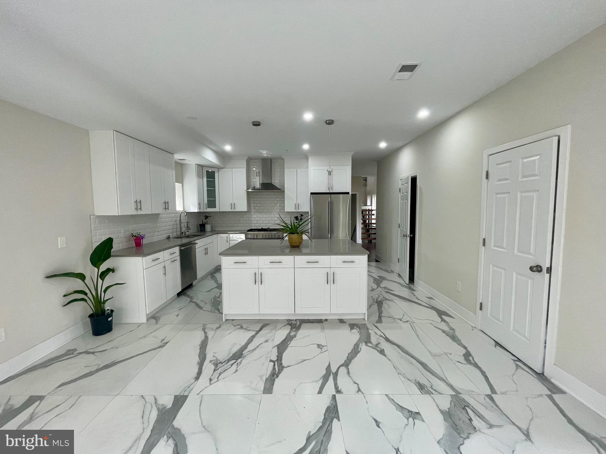 8618 Jones Mill Road Chevy Chase, MD 20815 - Photo 10 of 52 a large white kitchen with lots of counter space a sink and appliances