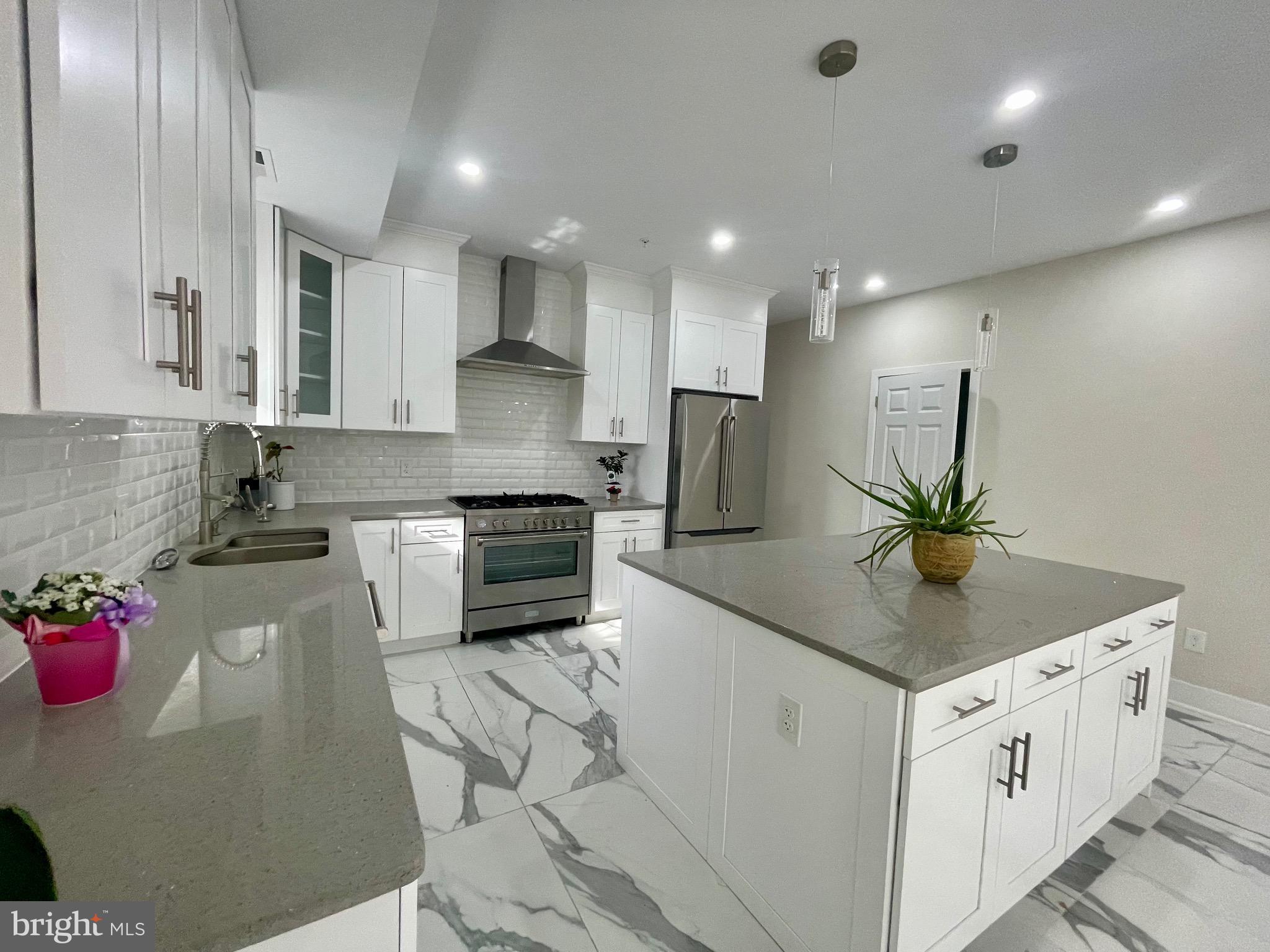 8618 Jones Mill Road Chevy Chase, MD 20815 - Photo 11 of 52 a kitchen with stainless steel appliances granite countertop a sink a stove and a refrigerator