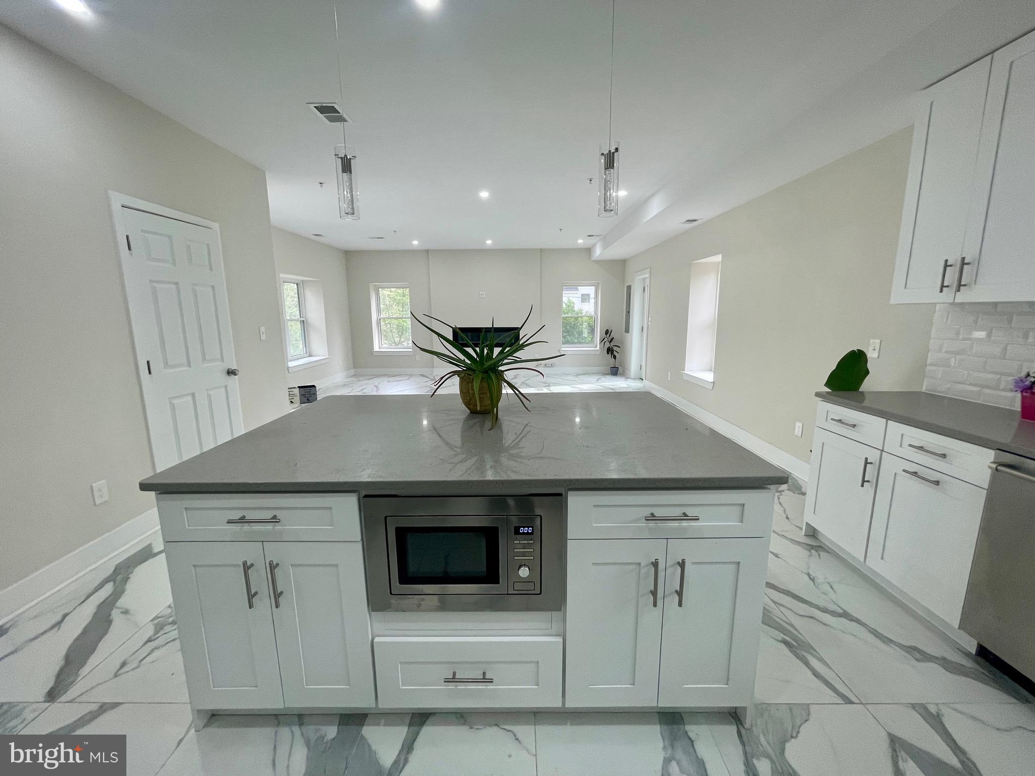 8618 Jones Mill Road Chevy Chase, MD 20815 - Photo 12 of 52 a kitchen with stainless steel appliances cabinets and a sink