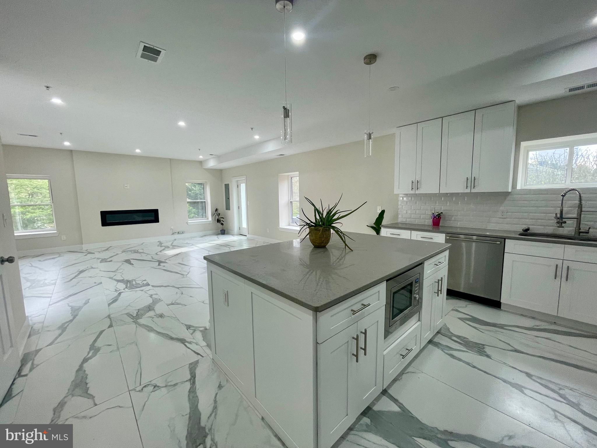 8618 Jones Mill Road Chevy Chase, MD 20815 - Photo 13 of 52 a kitchen with stainless steel appliances kitchen island granite countertop a sink and cabinets