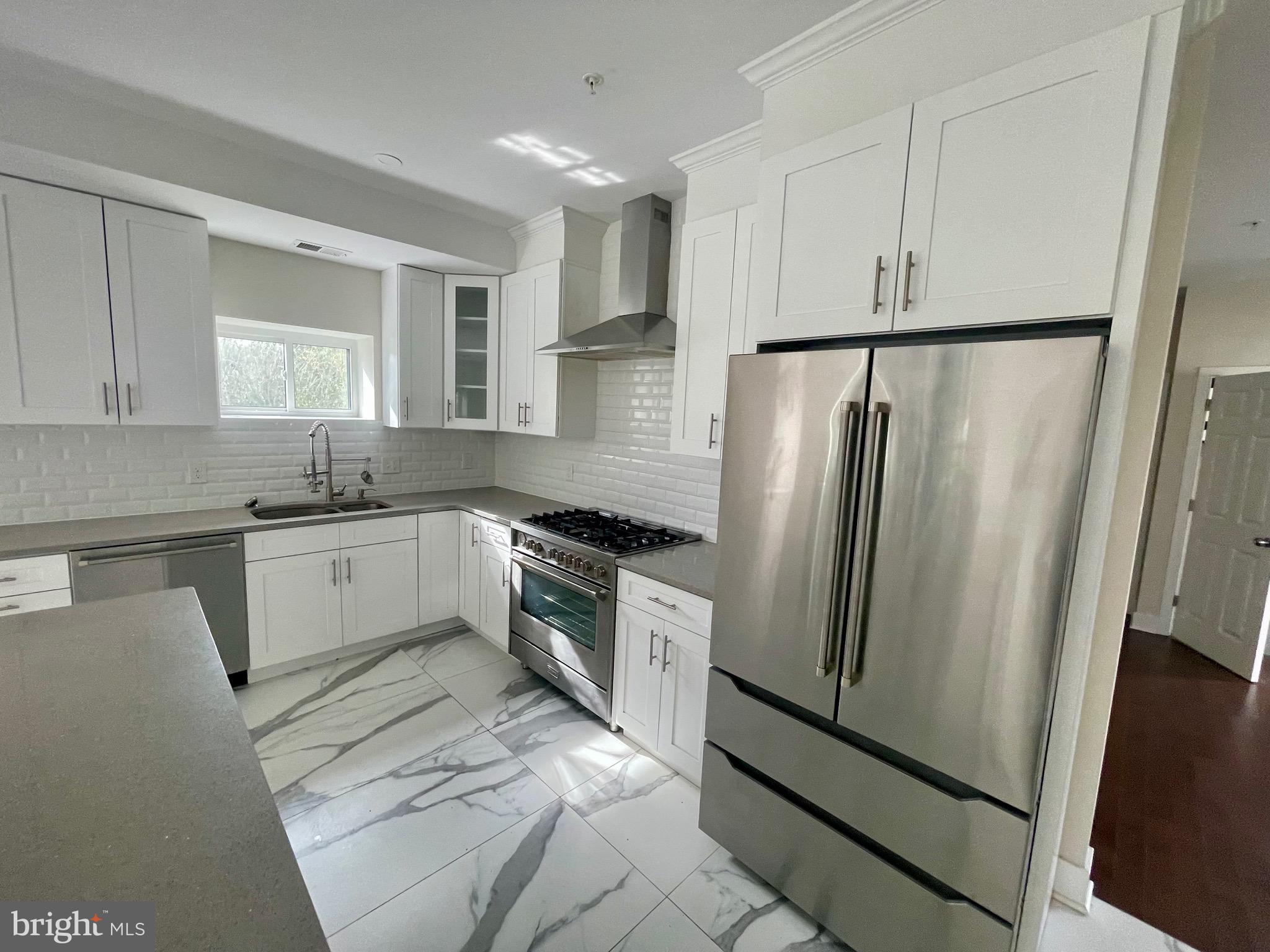 8618 Jones Mill Road Chevy Chase, MD 20815 - Photo 14 of 52 a kitchen with a refrigerator a sink and cabinets