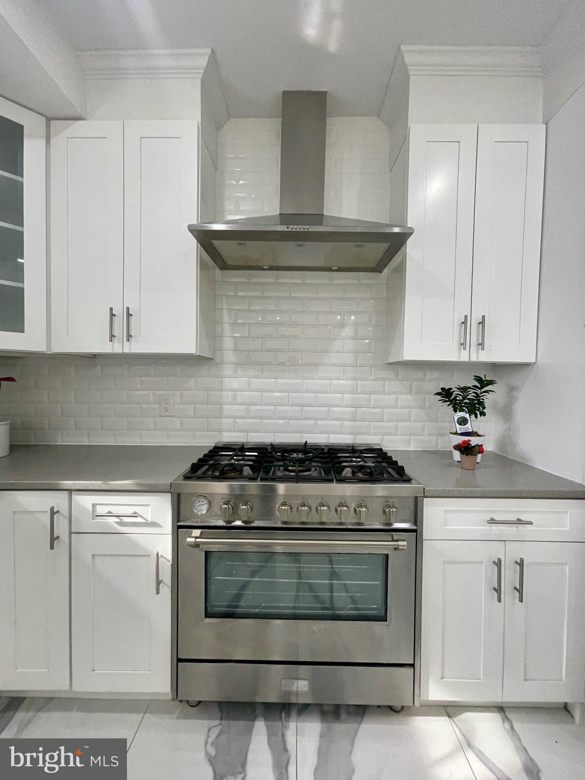8618 Jones Mill Road Chevy Chase, MD 20815 - Photo 15 of 52 a kitchen with white cabinets and appliances