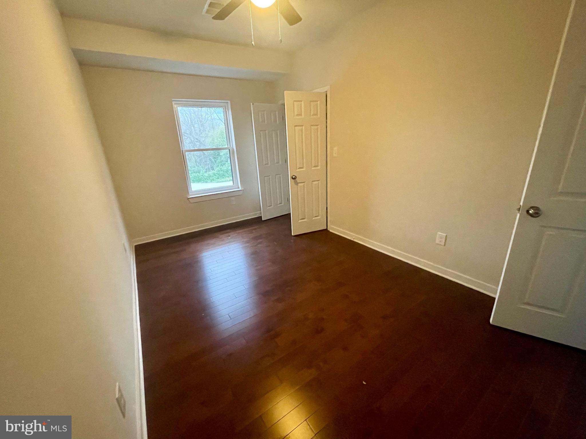 8618 Jones Mill Road Chevy Chase, MD 20815 - Photo 26 of 52 an empty room with wooden floor and windows