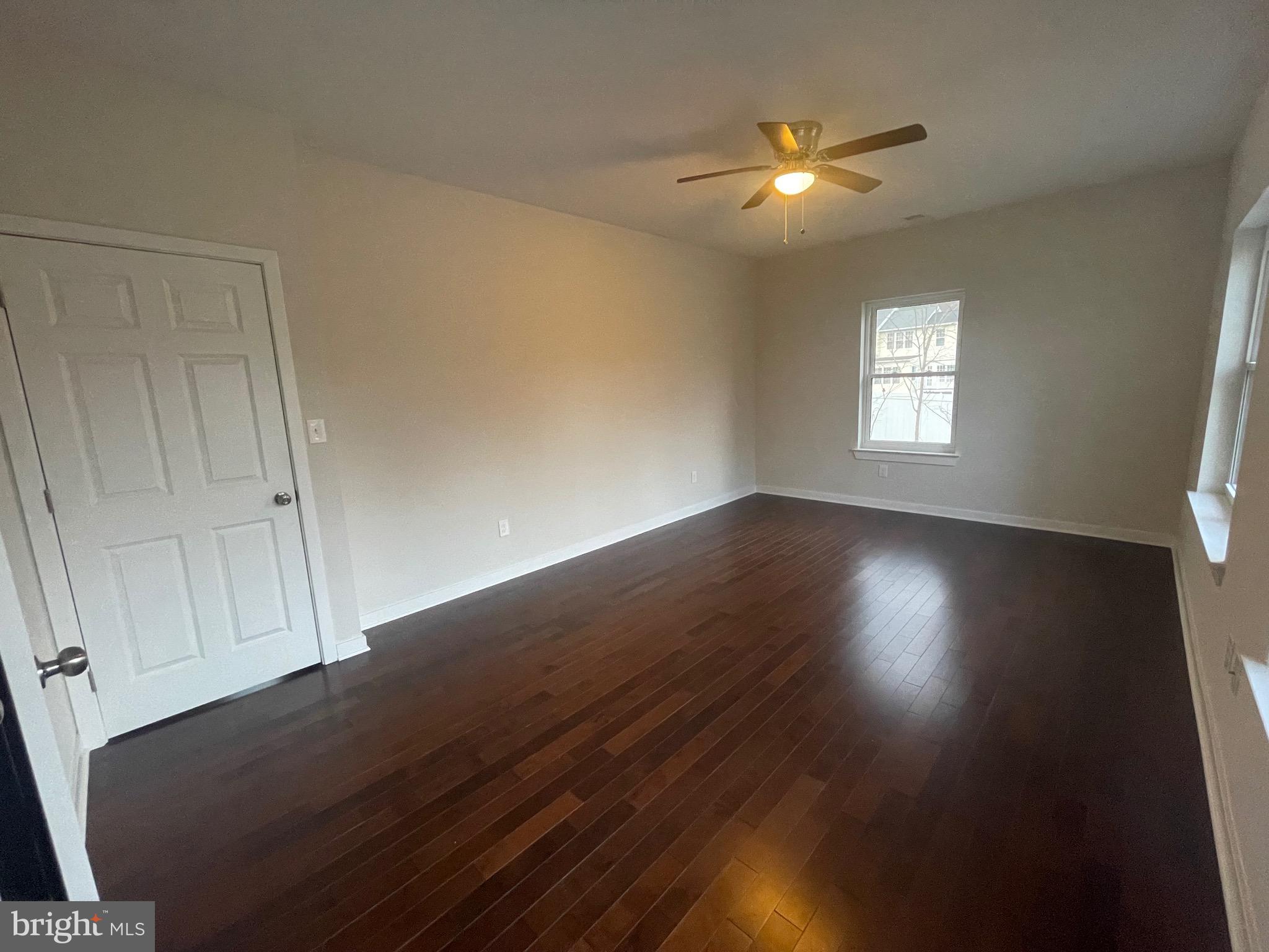 8618 Jones Mill Road Chevy Chase, MD 20815 - Photo 28 of 52 a view of wooden floor and a chandelier fan in a room