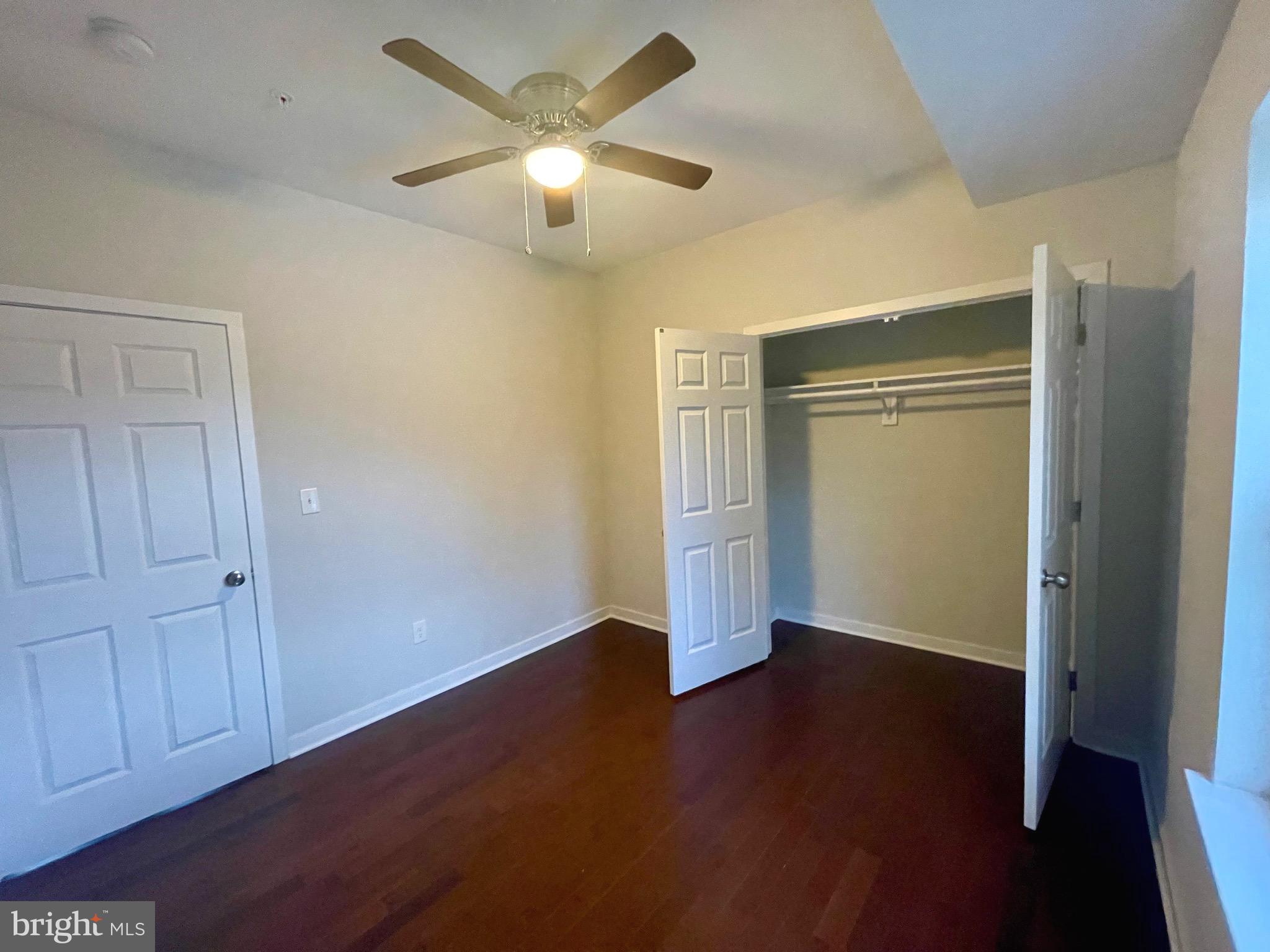 8618 Jones Mill Road Chevy Chase, MD 20815 - Photo 32 of 52 an empty room with wooden floor closet and windows
