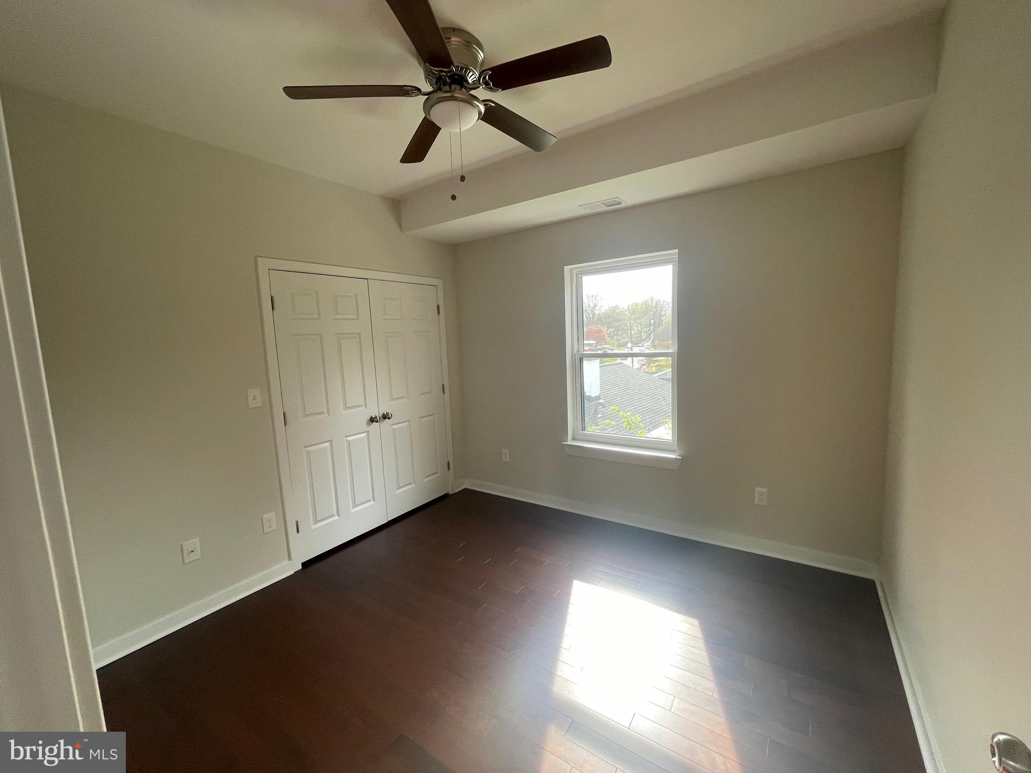 8618 Jones Mill Road Chevy Chase, MD 20815 - Photo 34 of 52 an empty room with a window and a ceiling fan