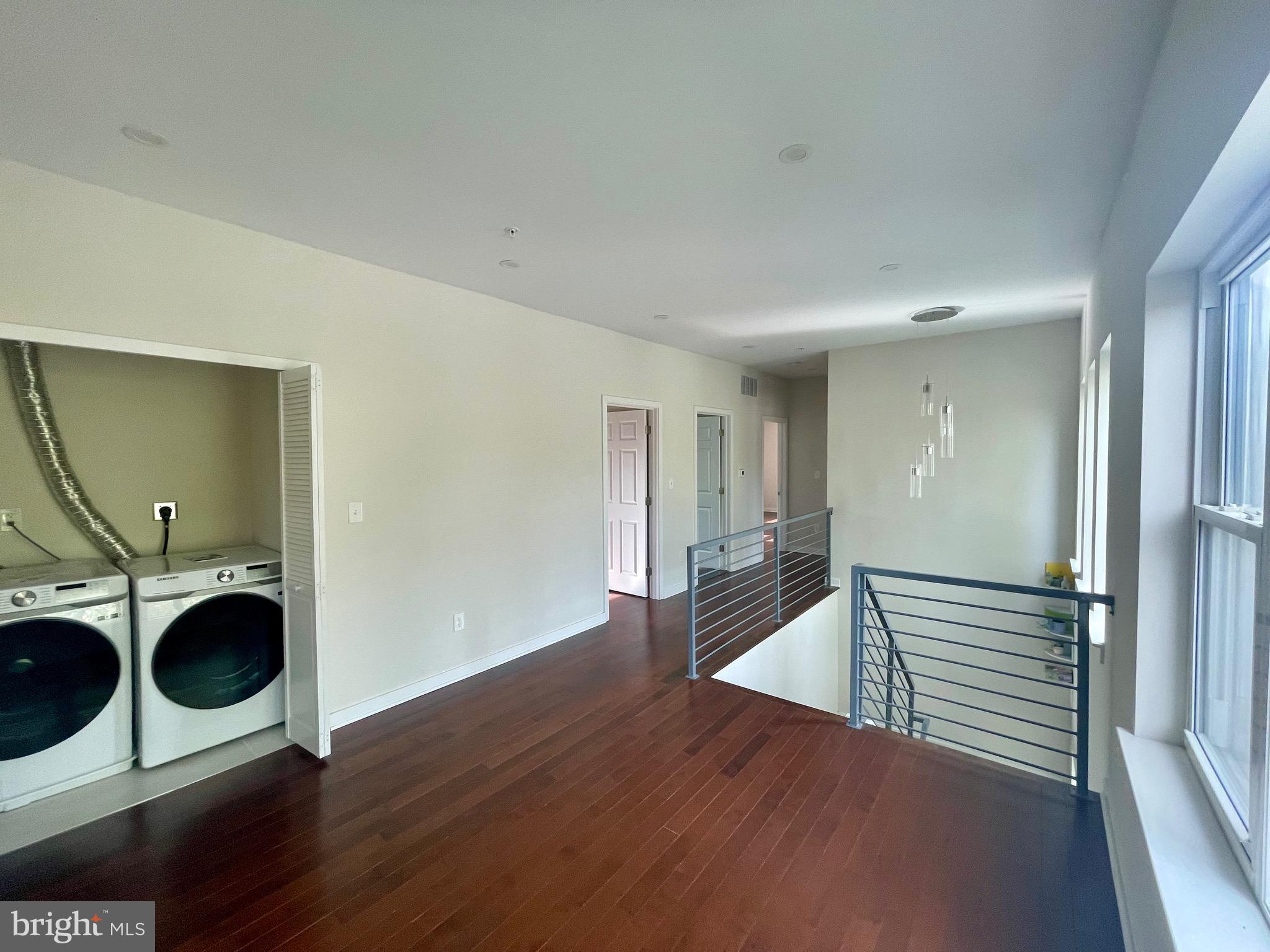 8618 Jones Mill Road Chevy Chase, MD 20815 - Photo 35 of 52 a view of a hallway with wooden floor and cabinets