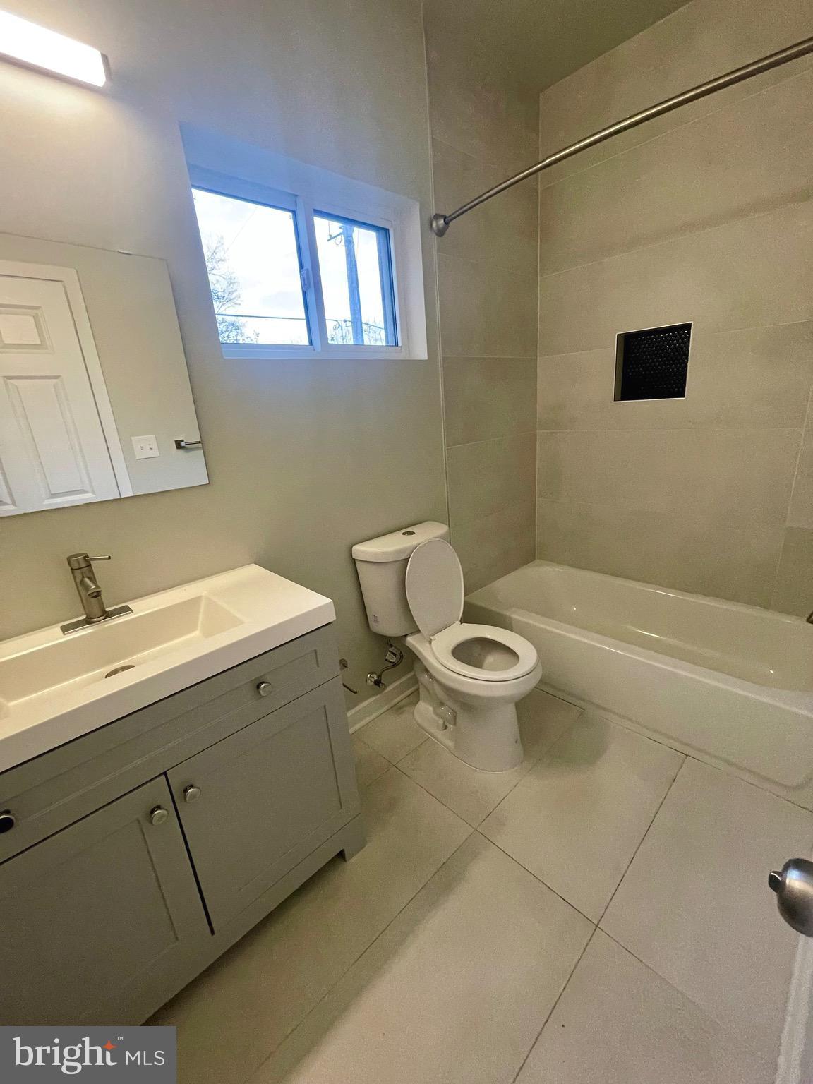 8618 Jones Mill Road Chevy Chase, MD 20815 - Photo 38 of 52 a bathroom with a granite countertop sink a toilet and a mirror