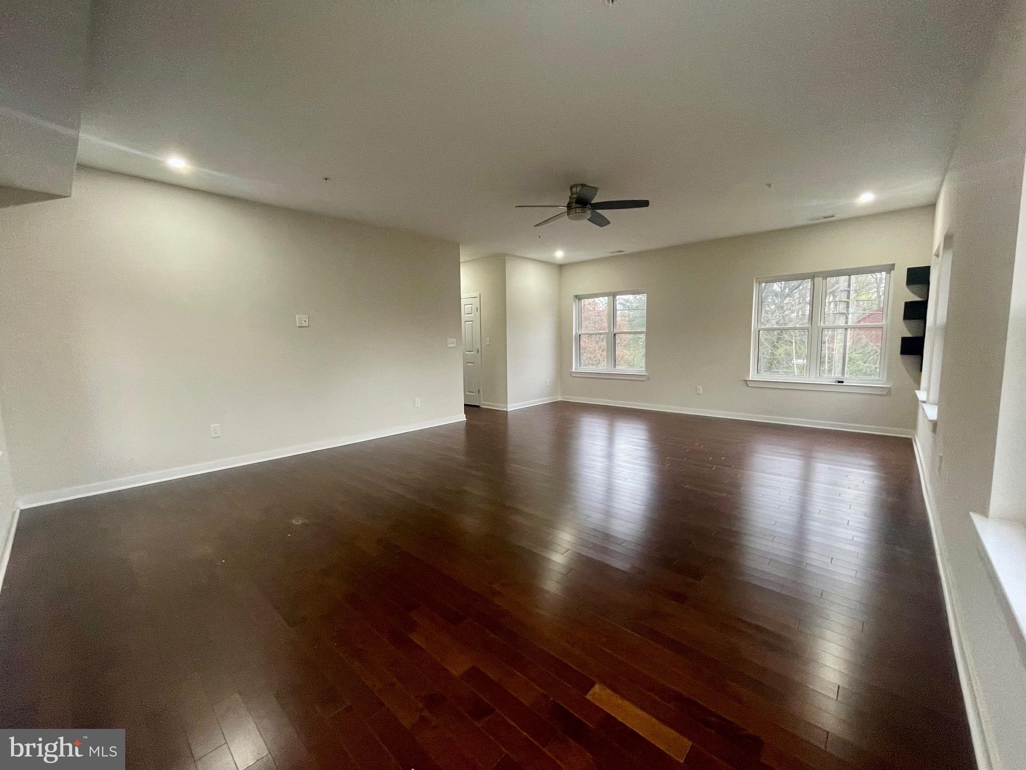 8618 Jones Mill Road Chevy Chase, MD 20815 - Photo 40 of 52 an empty room with wooden floor and windows