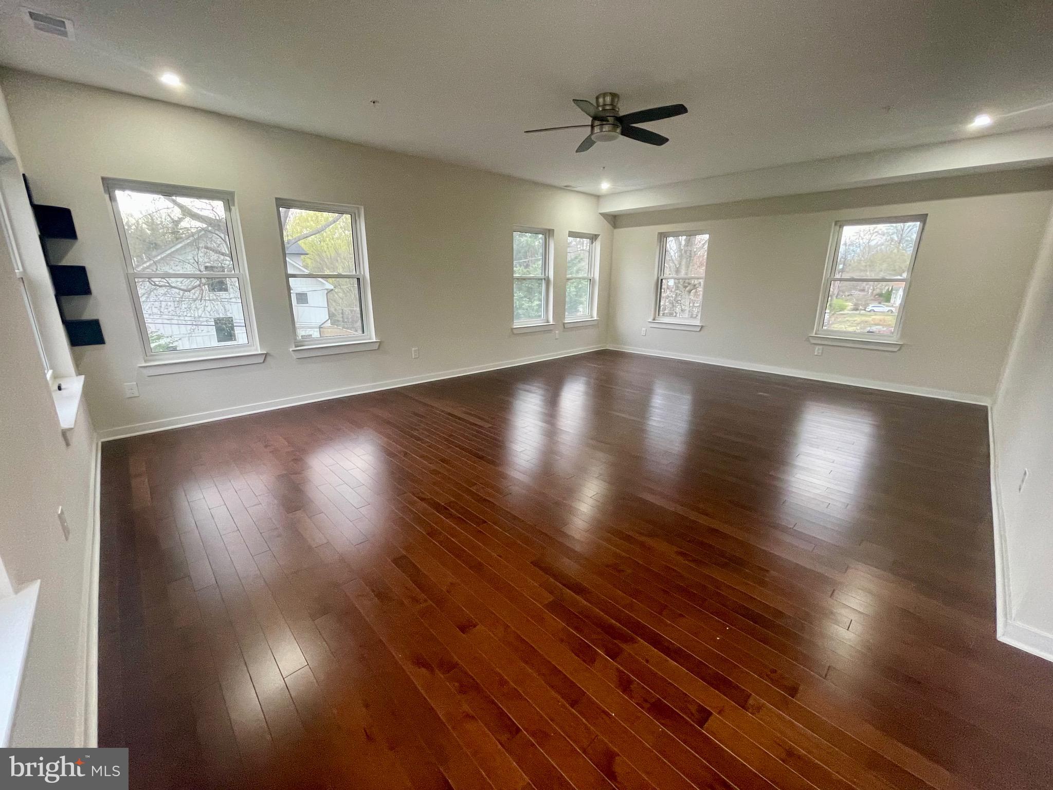 8618 Jones Mill Road Chevy Chase, MD 20815 - Photo 42 of 52 an empty room with wooden floor and windows