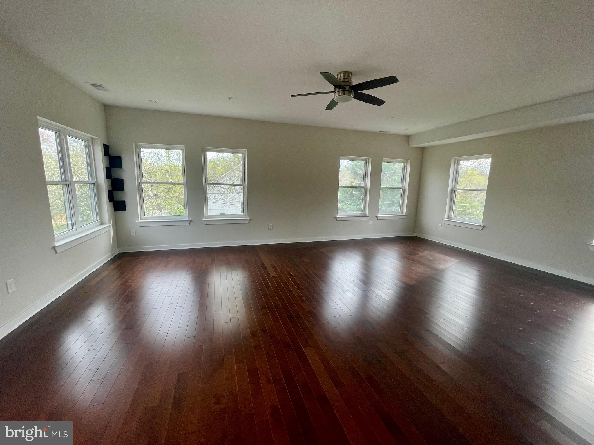 8618 Jones Mill Road Chevy Chase, MD 20815 - Photo 43 of 52 a view of an empty room with wooden floor and a window