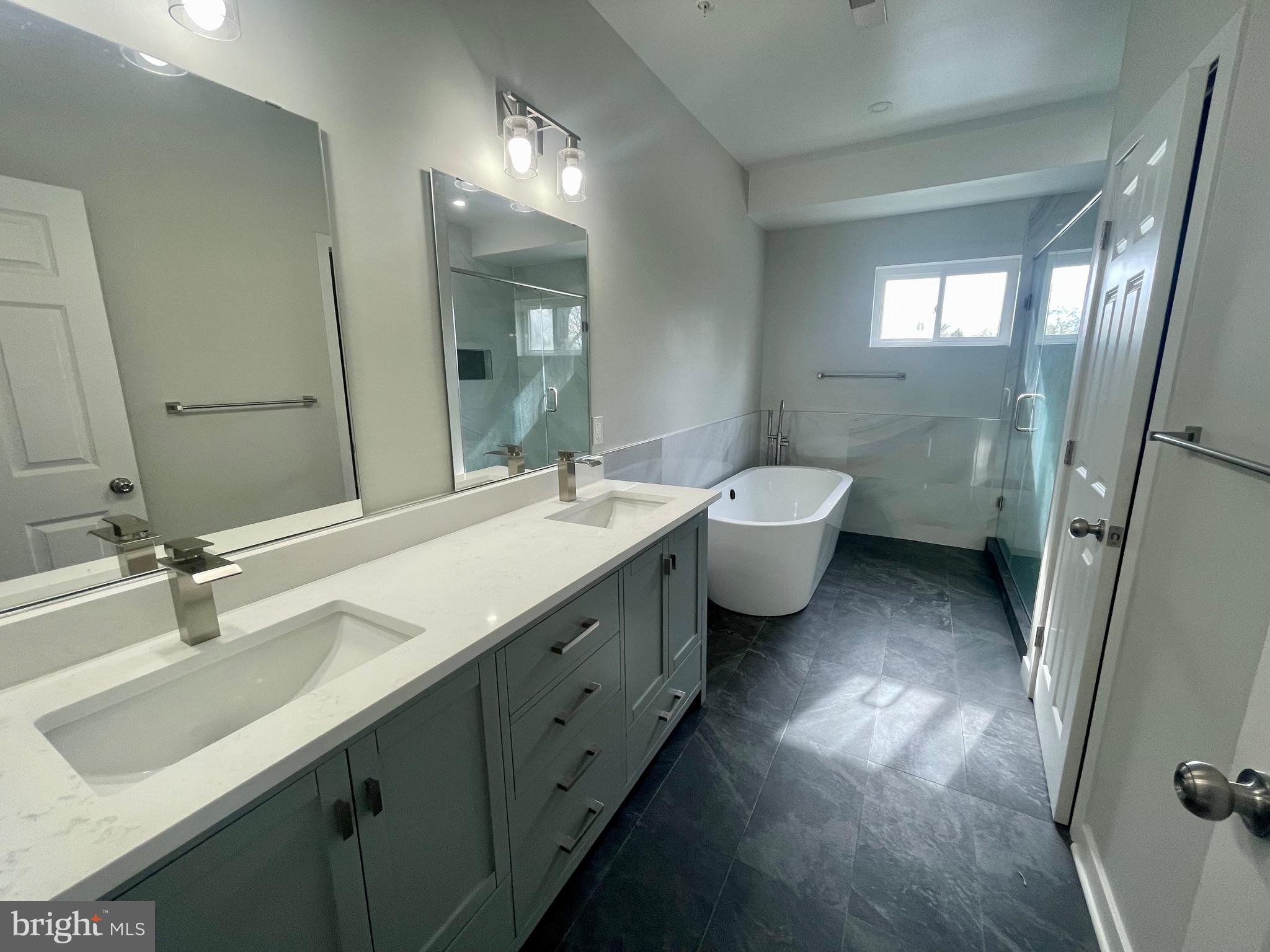8618 Jones Mill Road Chevy Chase, MD 20815 - Photo 45 of 52 a bathroom with a double vanity sink double mirror and toilet
