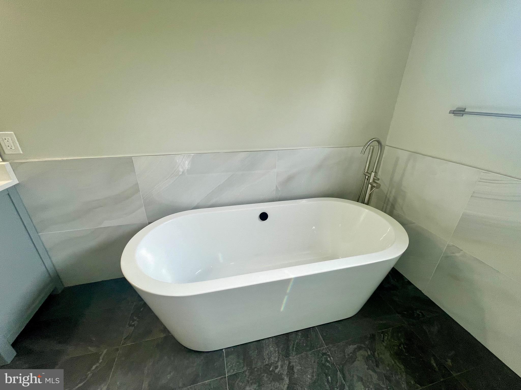 8618 Jones Mill Road Chevy Chase, MD 20815 - Photo 47 of 52 a white bath tub sitting in a bathroom