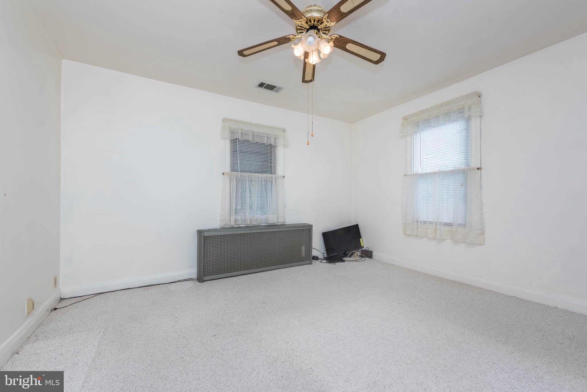 3417 East Joppa Road Baltimore, MD 21234 - Photo 12 of 51 en empty room with windows and ceiling fan