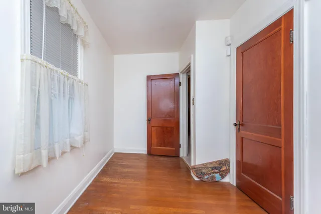 a view of a hallway with a refrigerator
