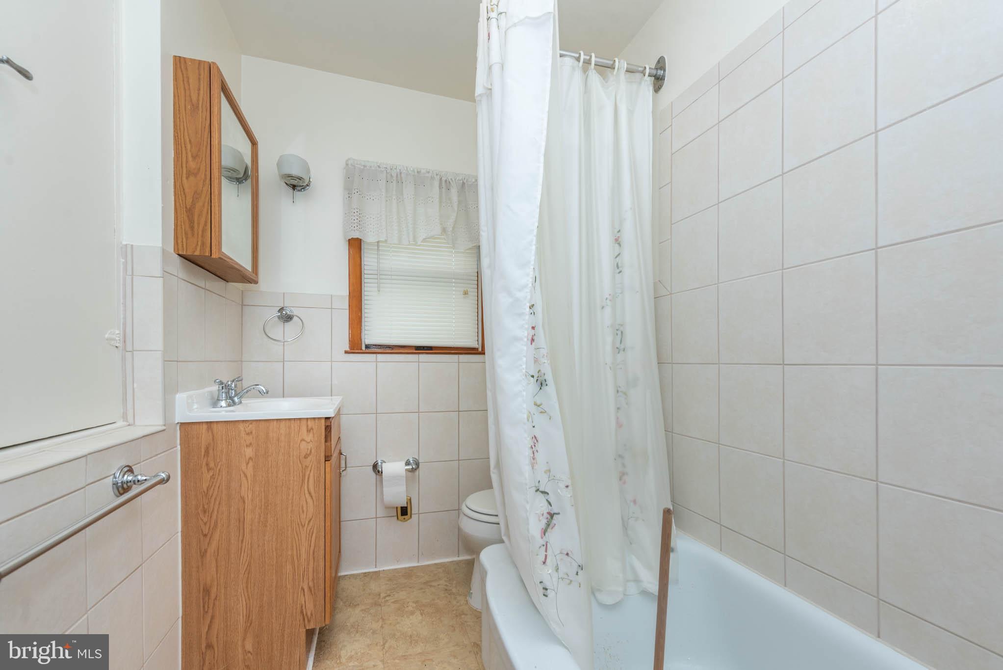 3417 East Joppa Road Baltimore, MD 21234 - Photo 29 of 51 a bathroom with a sink a toilet and shower