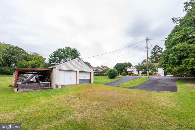 a view of yard with swimming pool and green space