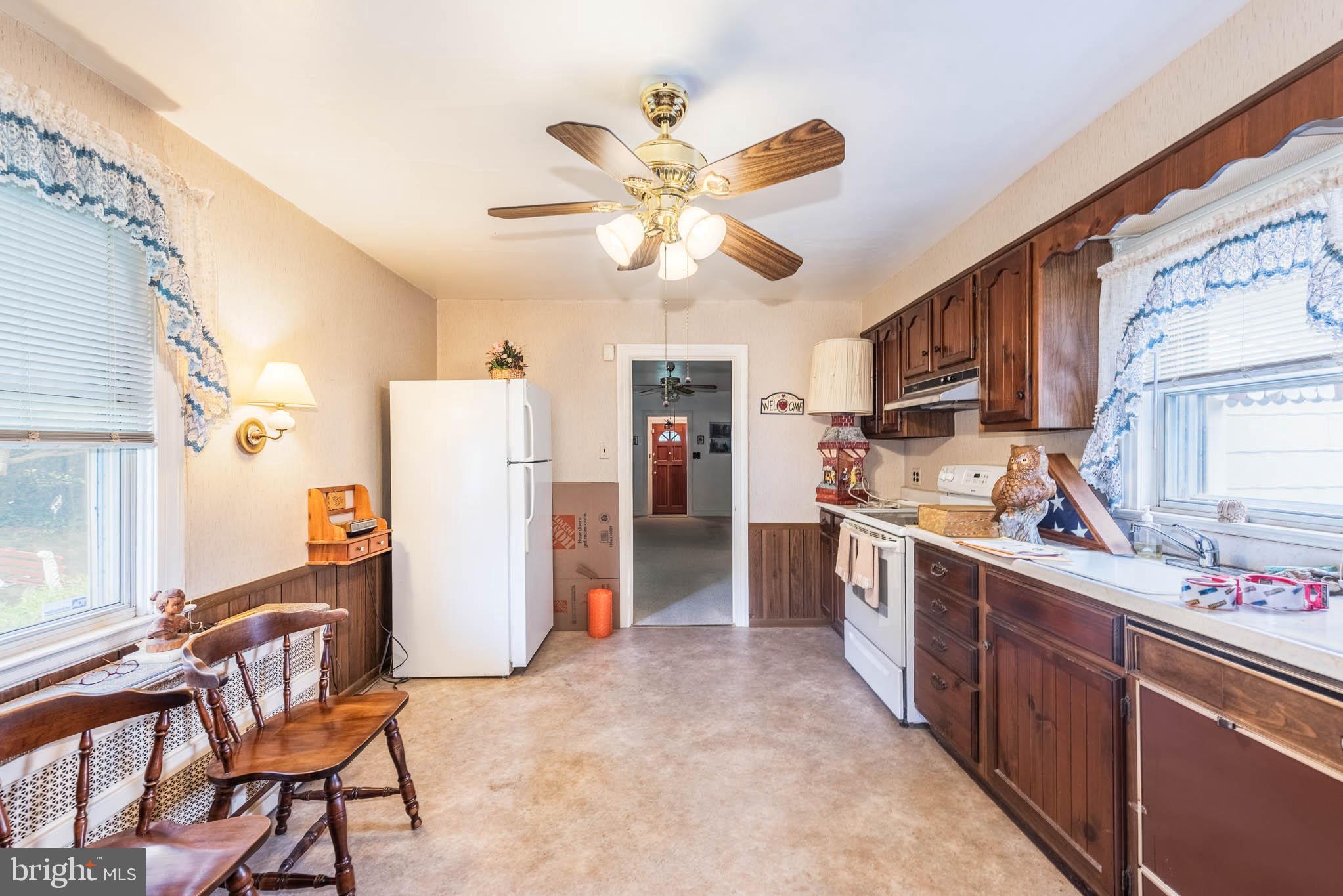 3417 East Joppa Road Baltimore, MD 21234 - Photo 7 of 51 a kitchen with stainless steel appliances kitchen island granite countertop a refrigerator a stove top oven a sink and dishwasher