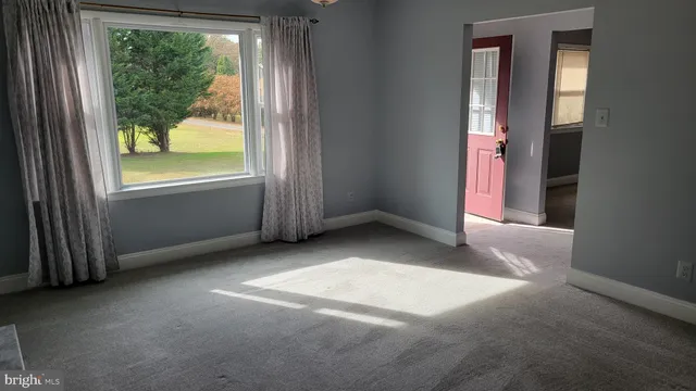a view of room with window and hallway