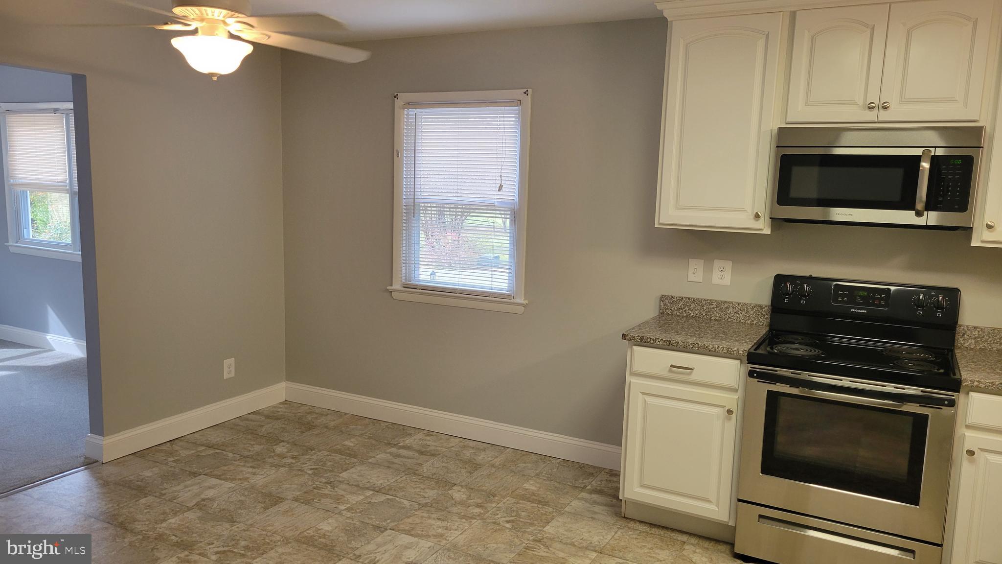 29620 Whalen Road Charlotte Hall, MD 20622 - Photo 7 of 16 a kitchen with a stove and a microwave