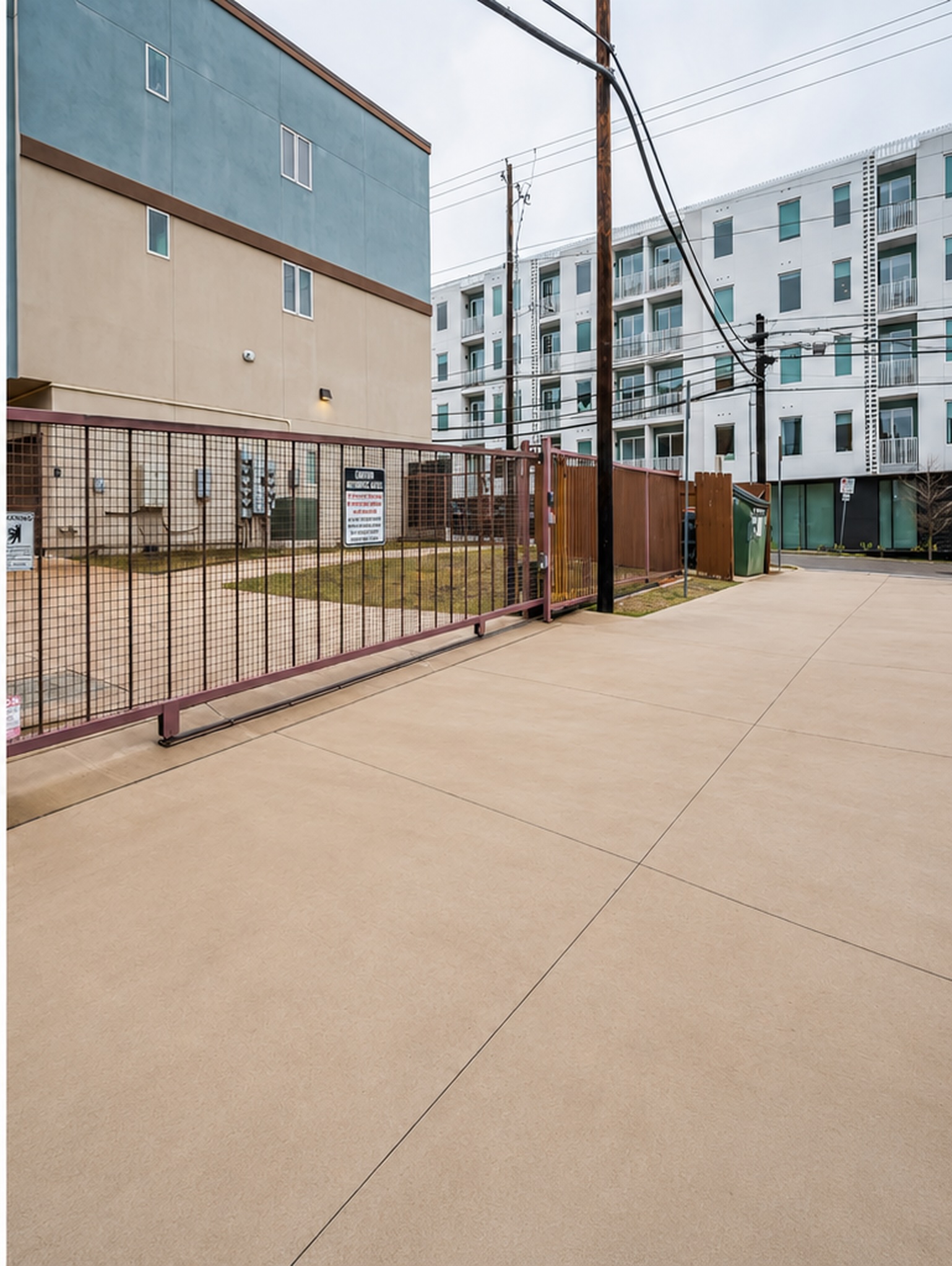 2827 Manor Road, Unit 3104 Austin, TX 78722 - Photo 21 of 30 Secure gated entry to a modern residential complex. Photo has been cleaned up with AI.
