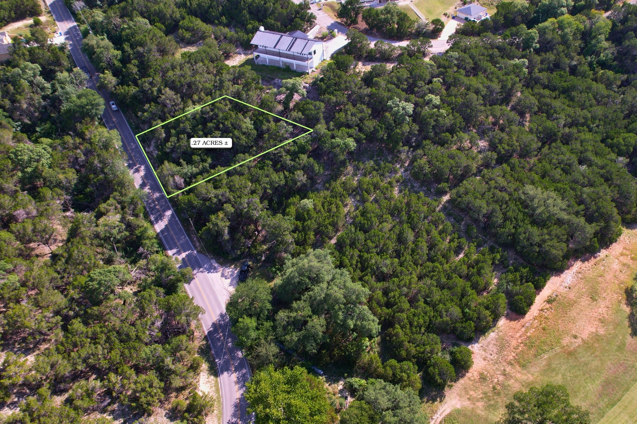 4500 Outpost Trace Leander, TX 78645 - Photo 7 of 13 A verdant, undeveloped lot awaits your vision, perfectly poised beside a tranquil roadway.