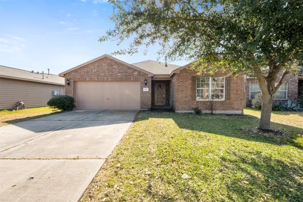 a view of a house with a tree in the background
